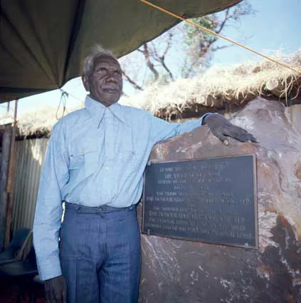 Vincent Lingiari standing near a plaque