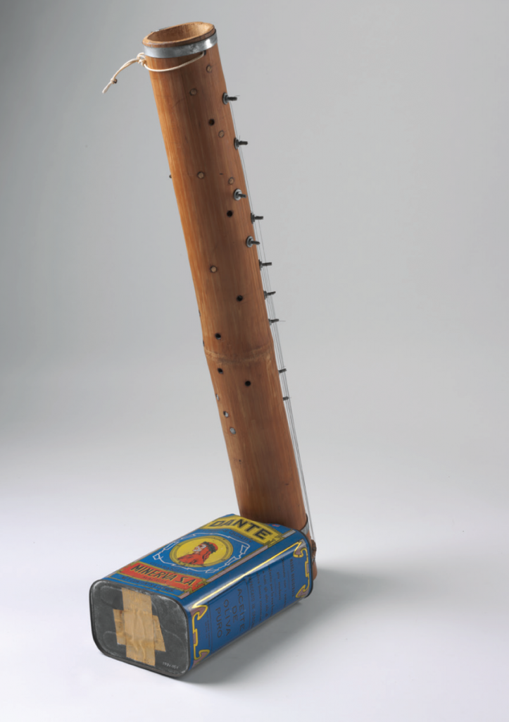 a twenty-three stringed instrument made by Minh Tam Nguyen in 1976 out of an old olive oil tin and a bamboo tube